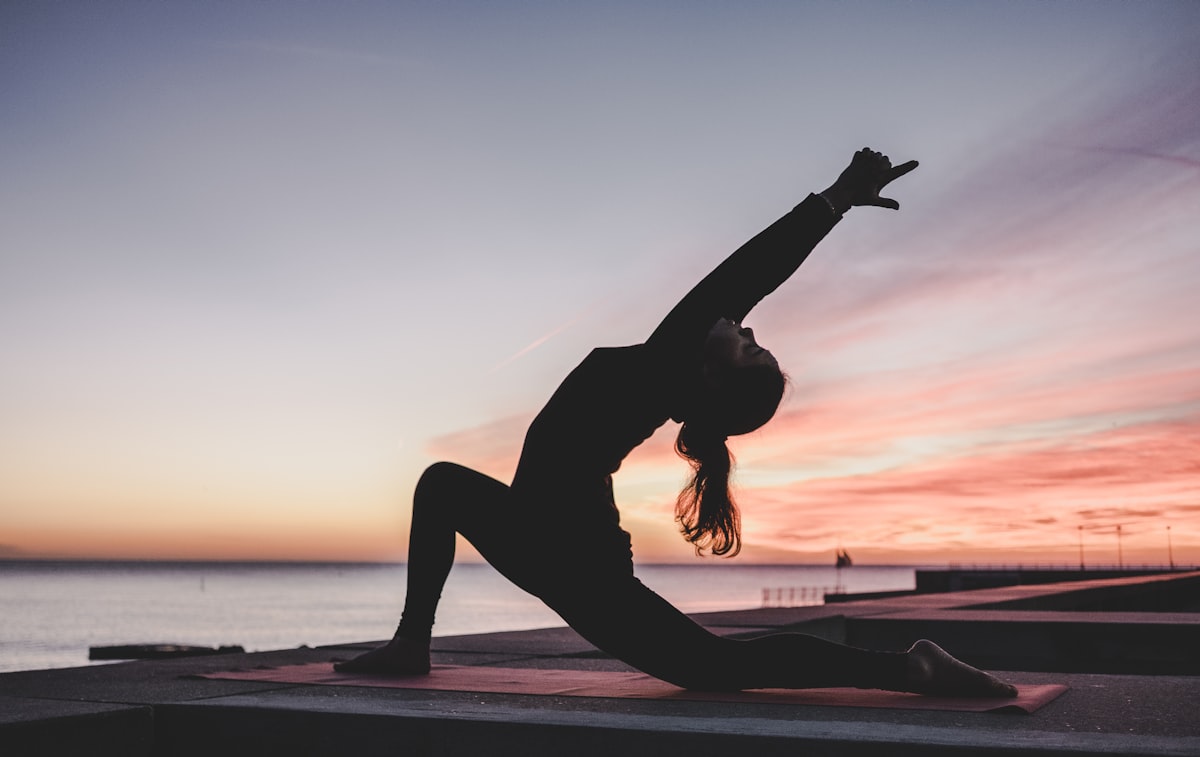 Silhouette of person in yoga pose at sunset - mind body embodied learning
